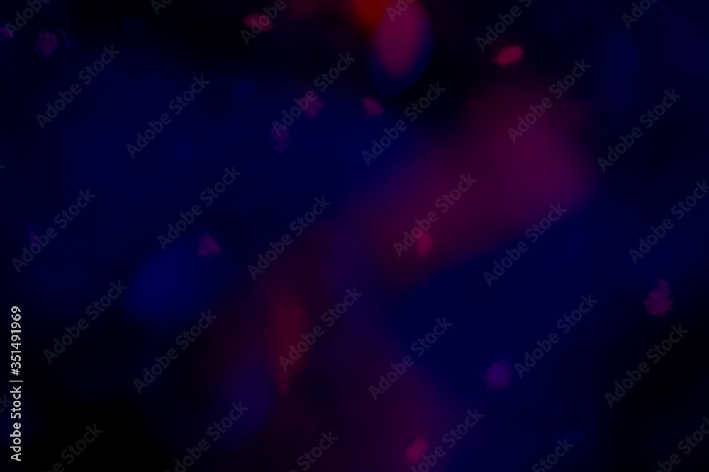 Wall mural red bokeh patterned on a dark blue background