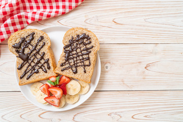 whole wheat bread with fresh banana, strawberry and chocolate