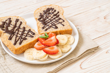 whole wheat bread with fresh banana, strawberry and chocolate