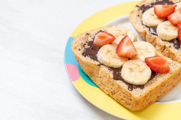 whole wheat bread with fresh banana, strawberry and chocolate