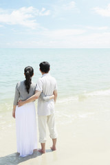 Man and woman enjoying the beautiful view on the beach