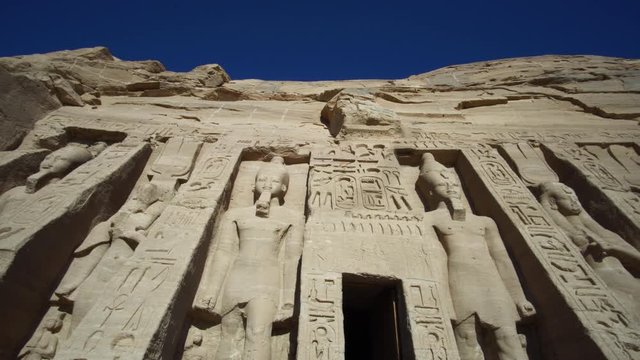 Pan shot of Abu Simbel temple facade Egypt Nubia landmark built by King Ramses II