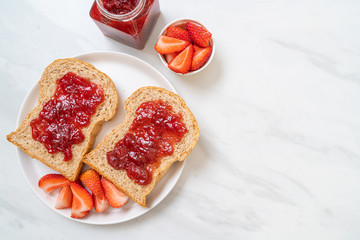 whole wheat bread with strawberry jam and fresh strawberry