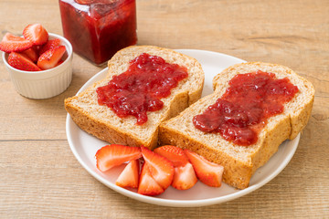 whole wheat bread with strawberry jam and fresh strawberry