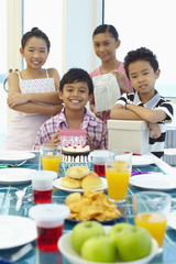 Children celebrating boy's birthday