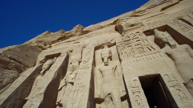 Pan shot of Abu Simbel temple facade Egypt Nubia landmark built by King Ramses II