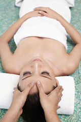 Obraz na płótnie Canvas Woman enjoying a facial massage