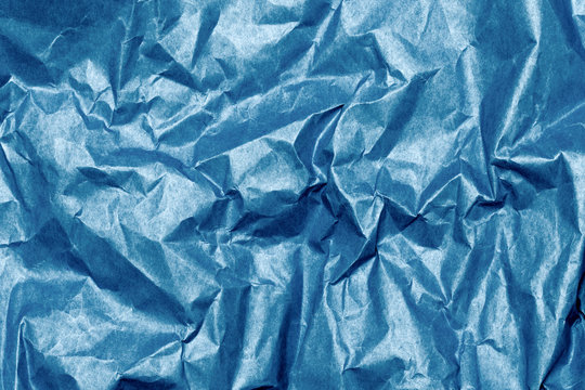 Crumpled blue paper textured background