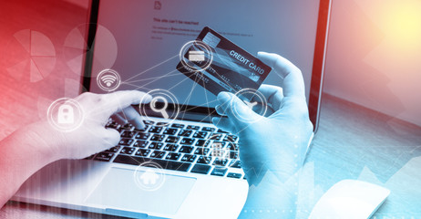 Business woman hand hold credit card to shopping internet online bill on computer, Debit saving purchase buy on table background. Shopaholic people retail pay sale money, bank terminal account concept