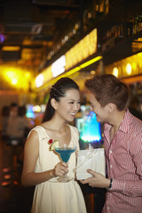 Man giving woman a surprise present