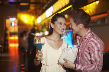 Man giving woman a surprise present