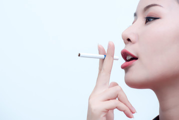 Fototapeta premium Close-up shots of a young woman who is pretending to smoke with a white background. ,Women Smoking.,Asian women smoke