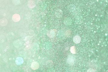 Glittery bokeh pattern on a green background