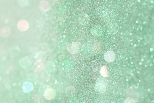 Glittery bokeh pattern on a green background