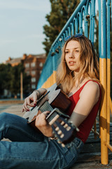 Learning to play the guitar. Beginner Guitar Lesson. Close-up of female hand playing Acoustic guitar. Music education and extra-curricular lessons