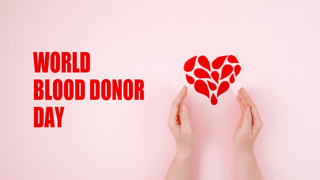 World Blood Donor Day. Blood donor day campaign for donation charity concept with red drops heart and hands. Giving blood saves lives