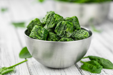 Frozen spinach cubes (close up; selective focus)