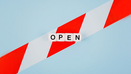 End of Coronavirus Quarantine, pandemic, post covid 19, open retail concept. Word OPEN on cut signal tape. What will be after Covid-19