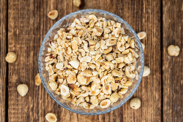 Portion of freshly chopped Hazelnuts (close up; selective focus)