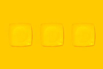 Yellow plates on a yellow background.