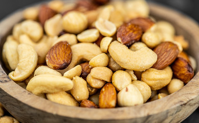 Roasted and salted nuts (close up; selective focus)