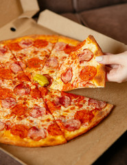 pizza with salami on a wooden table