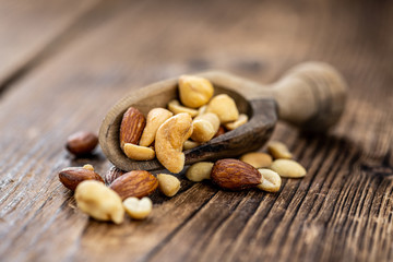 Roasted and salted nuts (close up; selective focus)