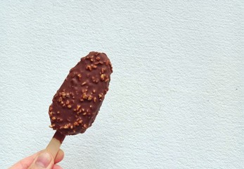 Chocolate ice cream with handles in the white wall background