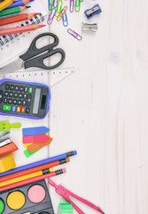 Fototapeta premium School supplies on white desk. Kids creativity flat lay