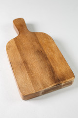 Brown board for slicing food on a white background