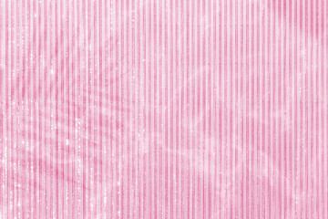 Pink palm leaf shadow on a lined pink background