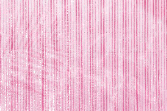 Pink palm leaf shadow on a lined pink background