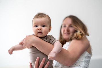 Mother playing with baby girl at home
