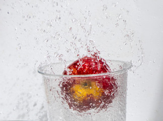 Red apple in the water splash. Fast shutter speed