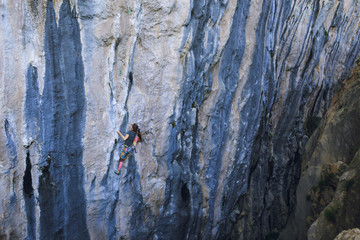 A strong girl climbs a rock, Rock climbing in Turkey.