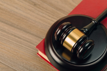 Judge gavel and laws books on a wooden table.