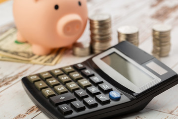 Coin money and banknote bills with a calculator. ballance reduction