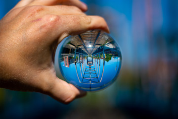 old rusty railway bridge seen through a glass ball