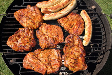 various meat and sausages on the charcoal grill
