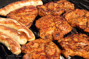 various meat and sausages on the charcoal grill