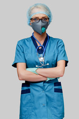 female doctor with stethoscope wearing protective mask and latex gloves over light grey background