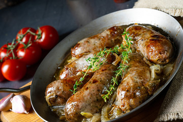 Homemade white sausage fried with onion and herbs
