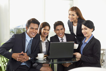 Happy business people smiling at the camera