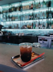 Iced americano with snacks on coffee bar. 