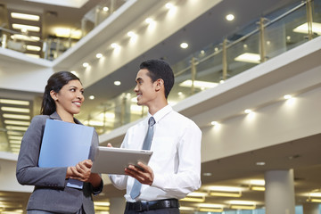 Business partners discussing by using tablet