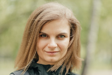 smile. young girl with voluminous wheat hair outdoors. close-up. girl smiling
