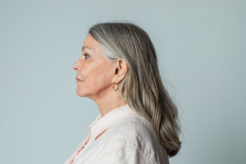 Senior woman wearing eyeglasses in a profile shot - Powered by Adobe