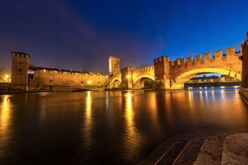 Castelvecchio and Ponte Scaligero (Old Castle and Scaligero bridge), at night with the River Adige in Verona downtown, UNESCO world heritage site, Veneto, Italy, Europe