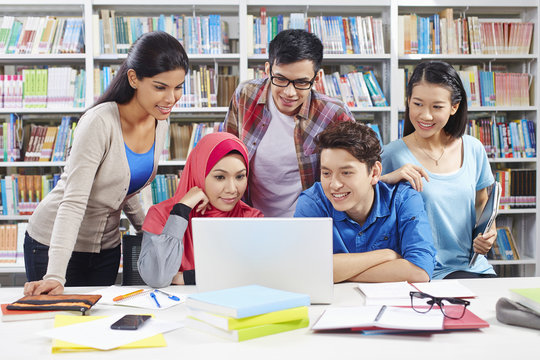 Students studying together in library