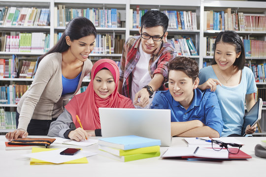 Students studying together in library